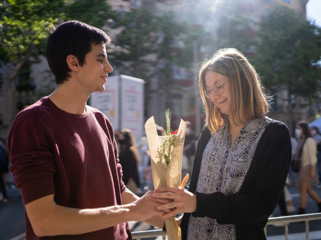 Man giving flowers to a woman