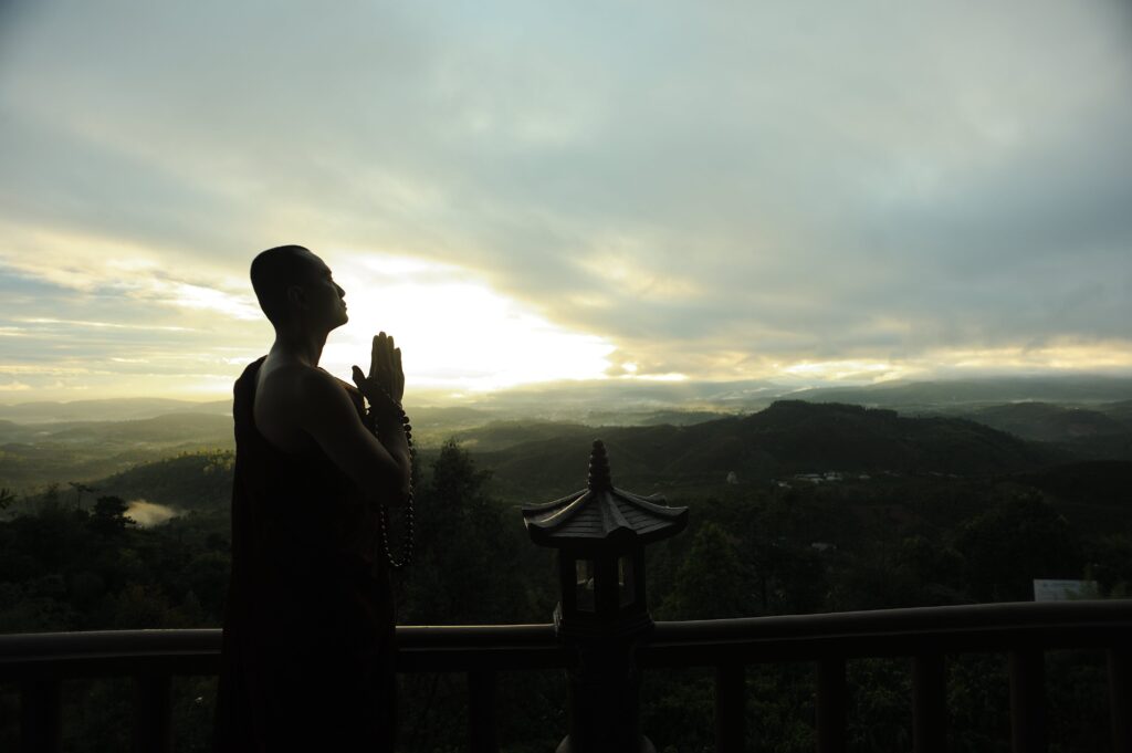 Monk accessing the spiritual realm via meditation and prayer