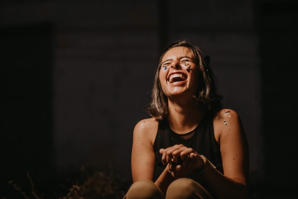 Woman laughing with glitter